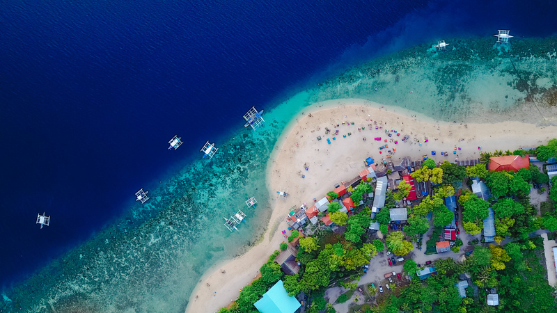 Aerial View of Sandy Beach with Tourists Swimming in Beautiful C